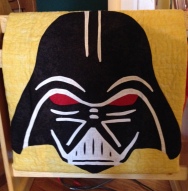 Darth Vader Mask on the Yellow Center of the Quilt. 